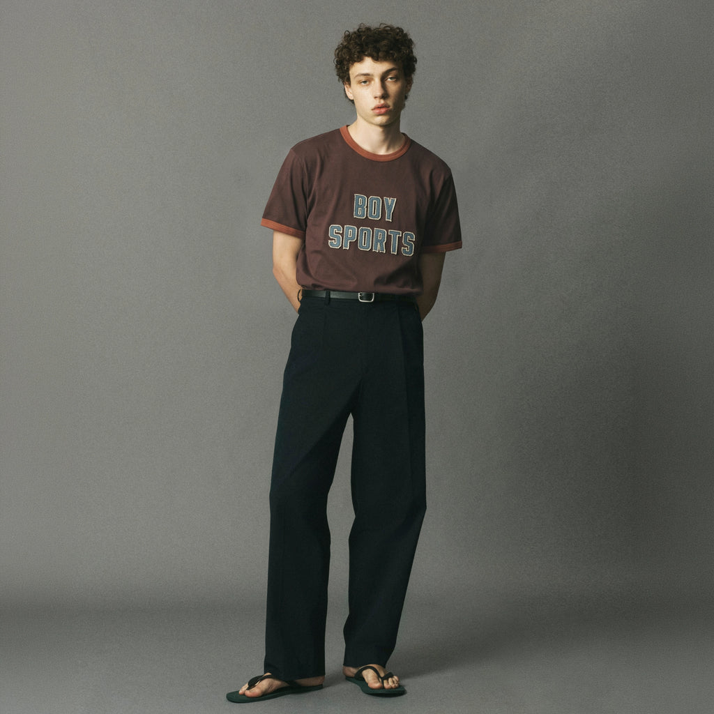 BOY SPORTS Ringer Tee — Brown ringer t-shirt with contrasting accents, featuring chenille-stitched varsity lettering. A cheeky, collegiate-inspired staple from the FW26 Collection with a nostalgic athletic feel.
