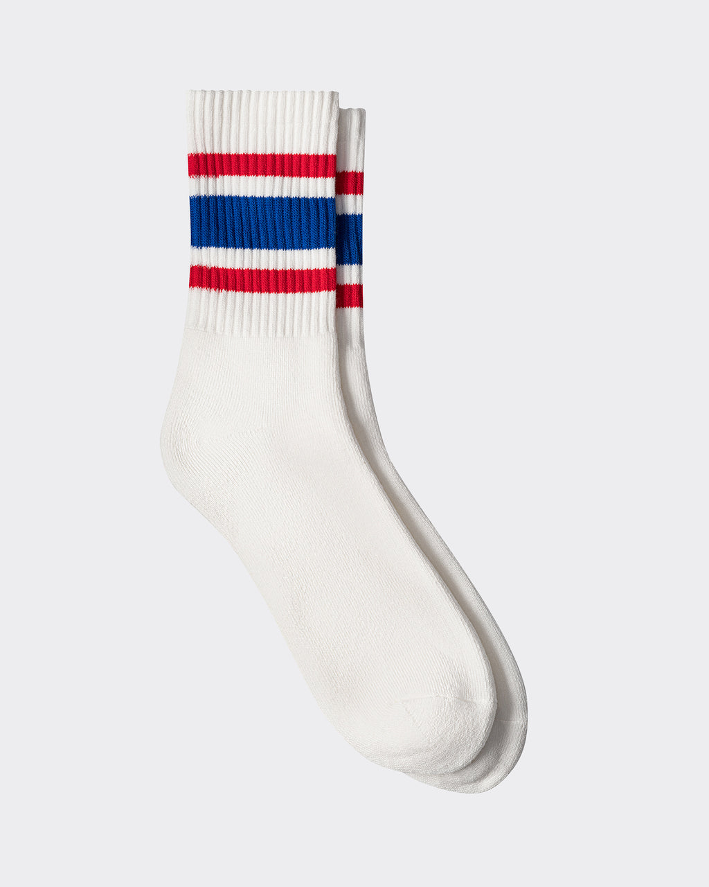 A pair of white athletic socks with blue and red stripes on the upper part.