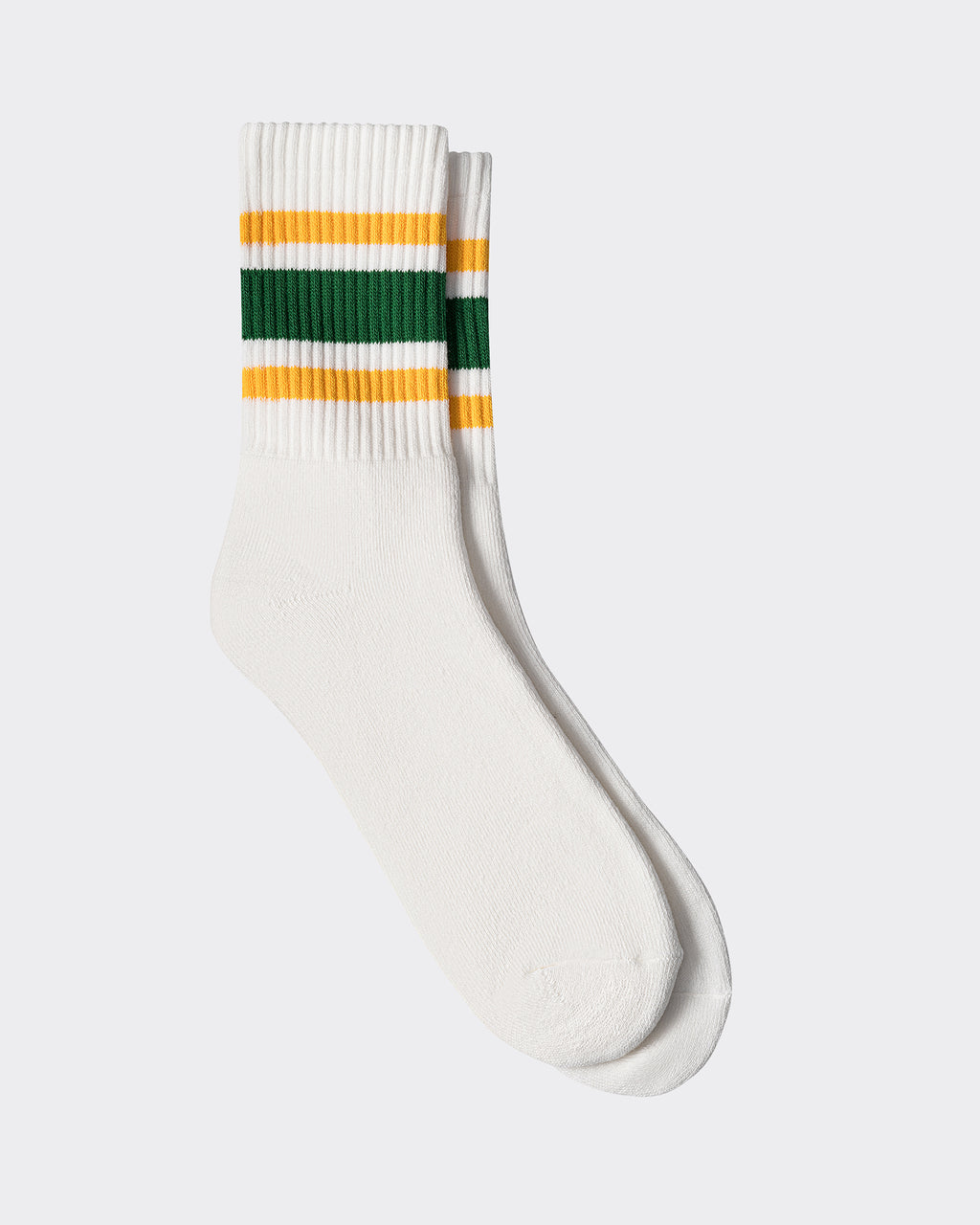 A pair of athletic socks with white as the primary color and green and yellow stripes near the top.