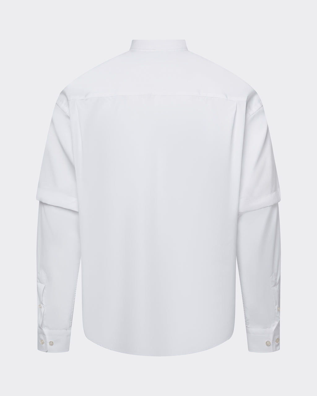 Back view of le PÈRE White Detached Sleeve Button Down shirt, emphasizing shirttail hem and paneled construction.