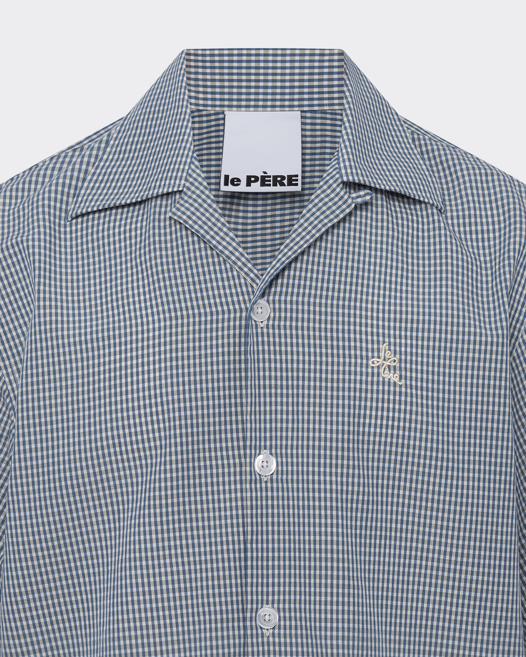 Green and white checkered shirt with 'le Pere' label on a light gray background