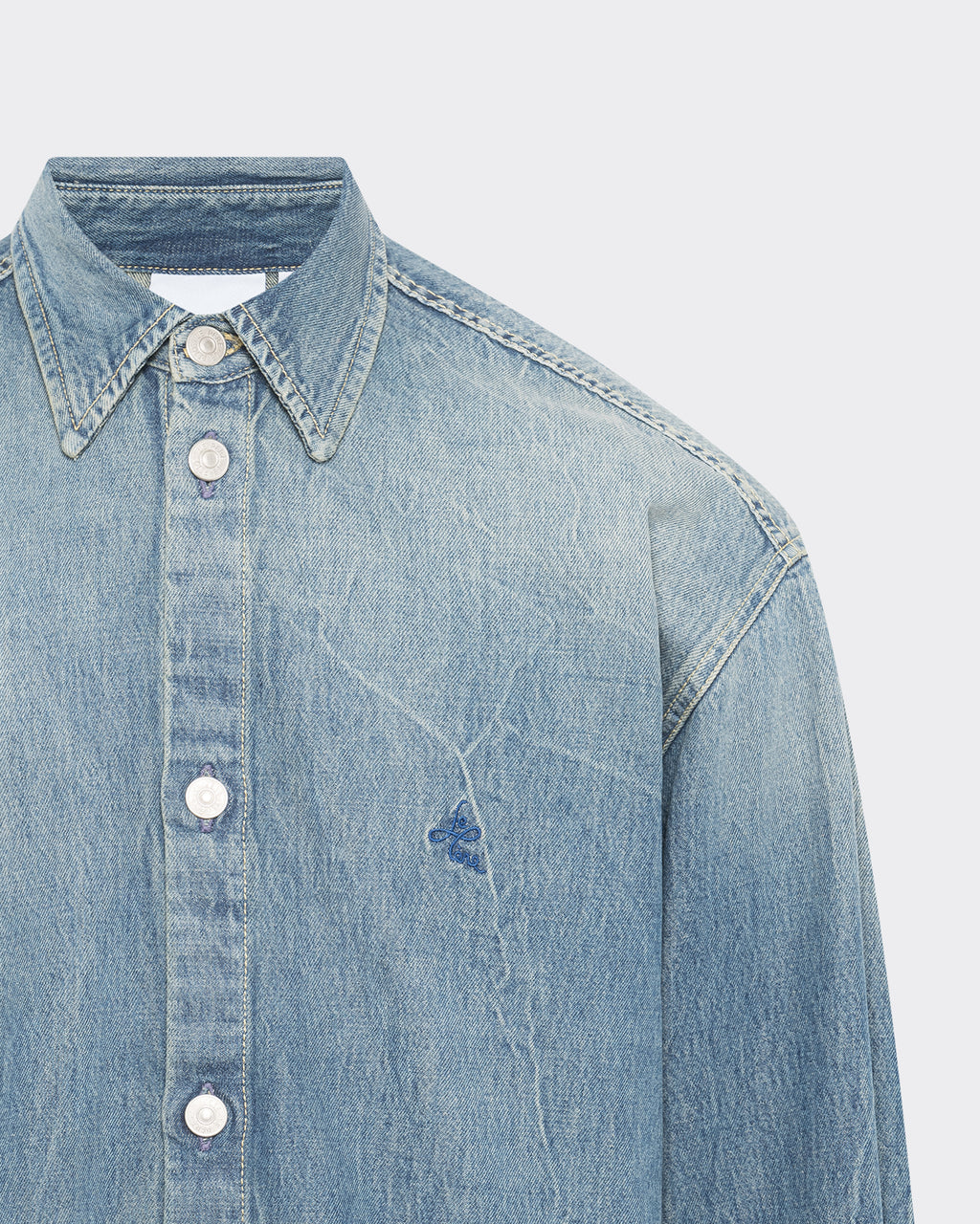 Close-up of collar and stitching on LE PÈRE washed denim button-up